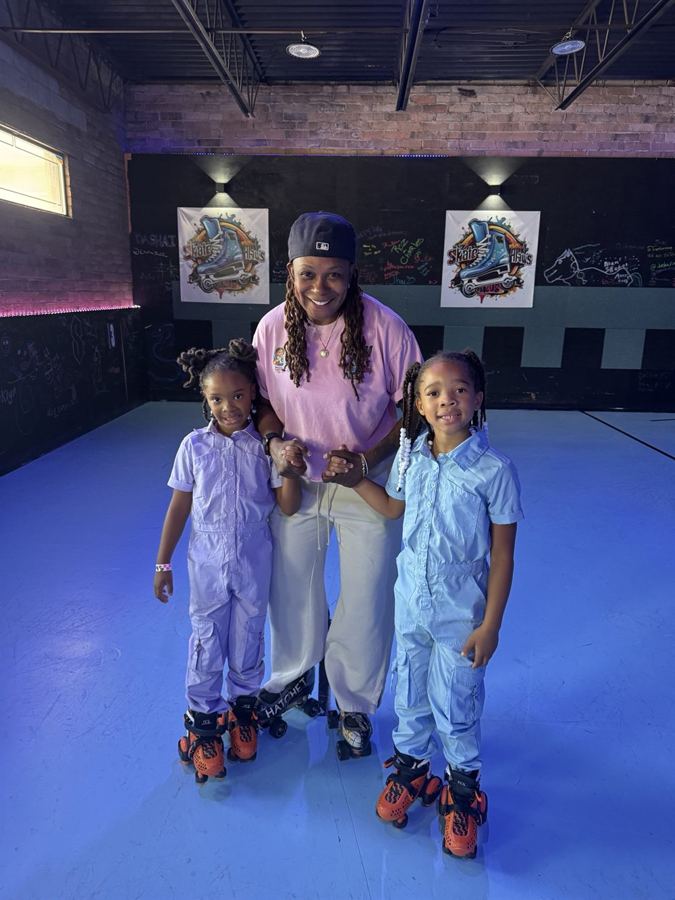 Rhonda Taylor on the rink with two young skaters